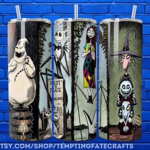three cylindrical tumblers with illustrations of characters from the movie " Nightmare Before Christmas".