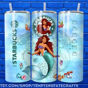 A Starbucks coffee can with a mermaid design, featuring the Starbucks logo and mermaid illustration.