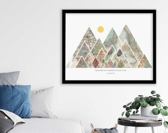 May include: A framed print with a mountain range made of vintage maps. The mountains are surrounded by a white background with a yellow sun. The text "Together is my favorite place to be" is at the bottom of the print.