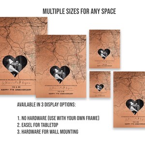 May include: A personalized map print with a heart-shaped cutout featuring a couple's photo. The map is in a copper color with black lines and text. The text reads "What began... You & Me Happy 7th Anniversary". The print is available in multiple sizes and display options.
