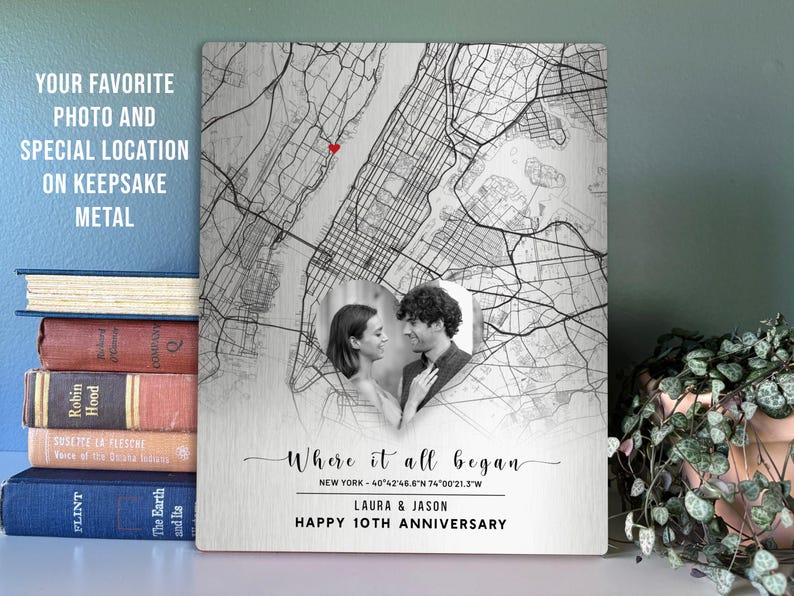 May include: A metal keepsake featuring a map of New York City with a heart marking a location. A black and white photo of a couple is centered. Text reads "Where it all began" and "Happy 10th Anniversary."