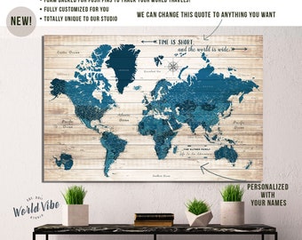 May include: A blue and white world map with push pins on a wood background. The map is framed and hanging on a white wall. The text "TIME IS SHORT, and the world is wide." is written on the map. The text "THE ALTHER FAMILY Life Is An Adventure" is written on the map. The text "PERSONALIZED WITH YOUR NAMES" is written below the map.