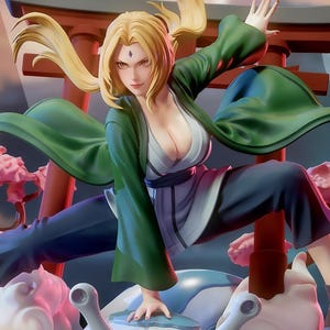 May include: A detailed figurine of a female anime character in a dynamic pose, wearing a green jacket, dark trousers, and sandals. The figure has blonde hair and is set against a backdrop of stylized clouds, pink trees, and a red gate. The base features a large, light blue orb.