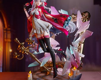 May include: A detailed figurine of a female character in a white dress and red cape, holding a mask. The figure is set against a backdrop of a decorative frame with crystal-like accents and a golden sword. The base includes lit candles.