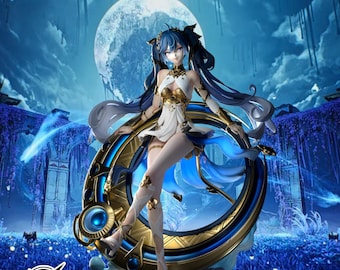 May include: A detailed figurine of a female character with blue hair and a white and gold outfit. She is posed with a large, ornate golden ring with blue accents. The background features a full moon and a fantasy landscape.