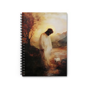 May include: Spiral-bound notebook with a religious painting. The image shows a figure in white robes wearing a crown of thorns, standing near a lamb. The background features a landscape with a tree and mountains, illuminated by warm light.