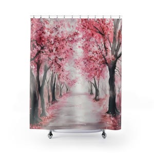 May include: A shower curtain with a watercolour painting of a path lined with cherry blossom trees. The trees have pink blossoms and dark grey trunks. The path is light grey, and the background is a soft, misty white.