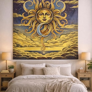 May include: A large tapestry featuring a celestial design with a sun face, crescent moon, and clouds. The artwork is in shades of yellow, blue, and gold, creating a dreamy aesthetic. The tapestry is hanging above a bed with neutral-toned bedding.