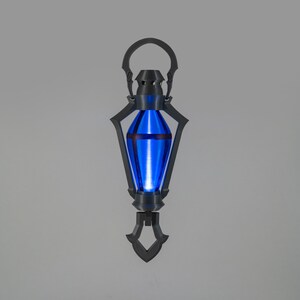 May include: A striking lantern with a vibrant blue interior light. The lantern features a black, decorative frame and a handle. The design is symmetrical, with a pointed base and a rounded top. The overall aesthetic suggests a fantasy or science fiction theme.