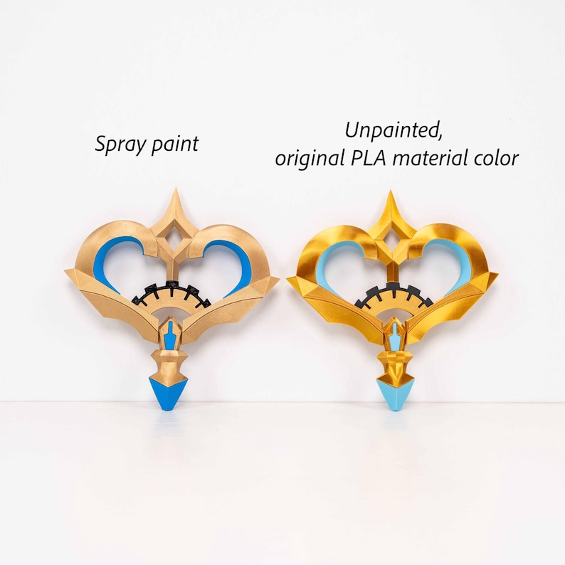 May include: Two decorative key-shaped objects, one spray painted and one unpainted. Both have a gold finish with blue accents and a black gear-like detail. The text "Spray paint" and "Unpainted, original PLA material color" are visible.