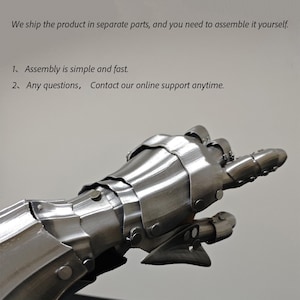 May include: A detailed, metallic gauntlet with articulated fingers, showcasing a medieval armor design. The image includes text stating the product ships in parts and is easy to assemble, with online support available.
