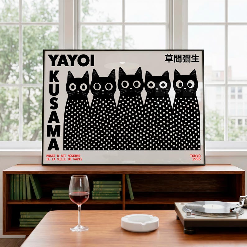 May include: A framed rectangular art print featuring five black cats with large white eyes and white polka dot bodies. The text YAYOI KUSAMA is printed vertically on the left, with Japanese characters, MUSEE D ART MODERNE DE LA VILLE DE PARIS, and TOKYO 1995.