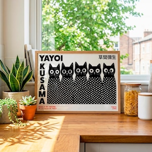 May include: A rectangular framed art print featuring five black cats with large white eyes and white polka-dot bodies. The text YAYOI KUSAMA is printed vertically in black on the left, with Japanese characters and TOKYO 1995 at the bottom.