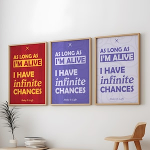 May include: Three framed posters with the text "AS LONG AS I'M ALIVE I HAVE infinite CHANCES" in white font. The backgrounds are red, purple, and white. The frames are light brown.