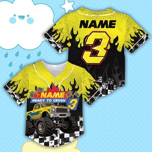 May include: Yellow and black baseball jersey with a monster truck graphic. The jersey features the number 3 in yellow and black, with the word "NAME" above it. The phrase "READY TO CRUSH" is also visible.