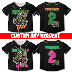 May include: Black baseball-style button-down shirts with green trim. The front features a T-Rex graphic with text reading BIRTHDAY BOY or BIRTHDAY GIRL. The back displays the text YOUR NAME above a large number 2 and a smaller T-Rex graphic.