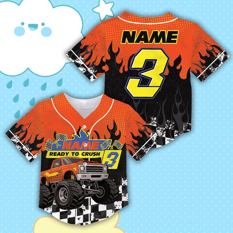 May include: Orange and black baseball jersey with a monster truck graphic. The jersey features the number 3 in yellow, the word "NAME" above the number, and the words "READY TO CRUSH" with a checkered flag design. The jersey has a white collar.