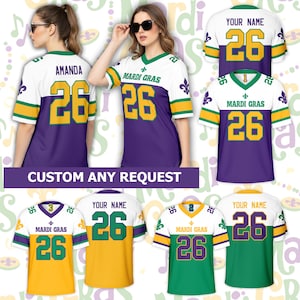 May include: Purple, white, and gold Mardi Gras jerseys with the number 26. The jerseys have the text "MARDI GRAS" and "YOUR NAME" on them. The image also shows the text "CUSTOM ANY REQUEST".
