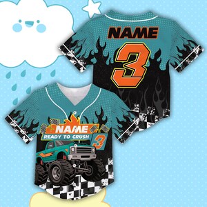 May include: Teal and black baseball jersey with a monster truck graphic. The jersey features the name and number 3 in orange, with the text "READY TO CRUSH". Flames and a checkered flag design complete the look.