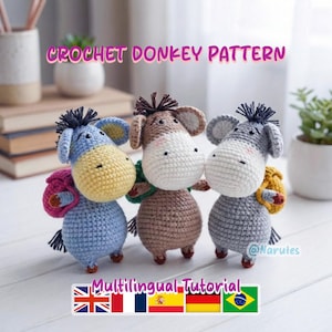 May include: Three crocheted donkey figures in blue, brown, and grey, each with a different coloured backpack. The donkeys have white faces and yellow, brown, and grey ears. The text "CROCHET DONKEY PATTERN" is above the donkeys, and "Multilingual Tutorial" is below.