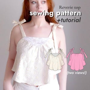 May include: A cream-colored Reverie top sewing pattern with a tutorial. The top features a square neckline, tie straps, and a floral pattern. Two views of the top are shown in the image, one cream and one pink.