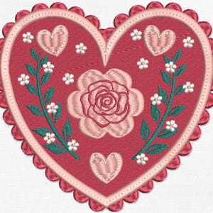 May include: Embroidered heart-shaped patch in shades of red and pink. Features a central rose, three hearts, and floral accents. The border has a scalloped edge. A decorative item.