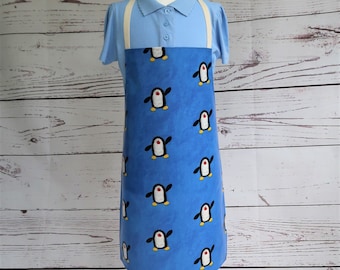 Tanzende Pinguine Blau Wachstuch Kinderschürze