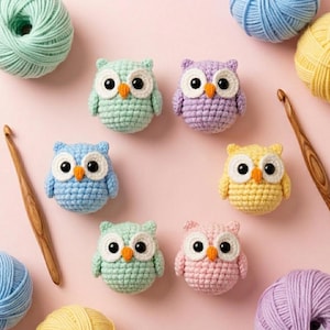 May include: A collection of colorful, crocheted owl figurines in various pastel shades, including blue, green, purple, yellow, and pink. The owls have large white eyes and orange beaks. Yarn and crochet hooks are also visible.