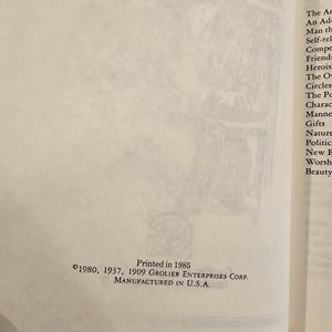 May include: Open book page with text and a logo. The text reads "Printed in 1985" and "&copy;1980, 1937, 1909 GROLIER ENTERPRISES CORP. MANUFACTURED IN U.S.A." The page is off-white with a faded illustration in the background.