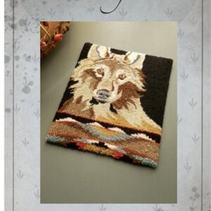 May include: A punch needle pattern for a wolf with a brown and black background. The pattern is 19 cm high and 14 cm wide. The pattern is called "Wolf" and is designed by Kate Gillery.