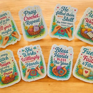 May include: A collection of colorful stickers with inspirational quotes related to crochet and knitting. Each sticker features illustrations of yarn, needles, and hands, with phrases like "Pray, Crochet, Repeat" and "Fueled by Faith & Fiber."