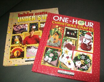 May include: Two craft books with red and brown covers. The book on the left has the title "Holiday Crafts Under $10" and the book on the right has the title "One-Hour Christmas Crafts". Both books feature images of holiday crafts.