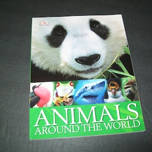 May include: A book cover with the title "Animals Around the World" featuring a close-up of a panda's face. The cover also includes images of a frog, a shark, a bird, and a monkey.