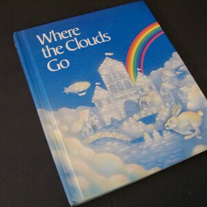 May include: A blue children's book titled "Where the Clouds Go" with a rainbow and a cloud castle on the cover.