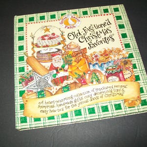 May include: A green and white checkered book cover with the title "Old Fashioned Christmas Favorites" and a heart-warming collection of treasured recipes, memories, handmade gifts, cozy decorating tips & easy how-to's for the joyous days of Christmas.