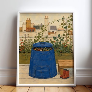 May include: A framed art print depicting a blue compost bin with an open lid filled with organic matter, situated on a wooden deck. Behind the bin is a raised garden bed with climbing vines and a city skyline featuring brick chimneys and rooftops.