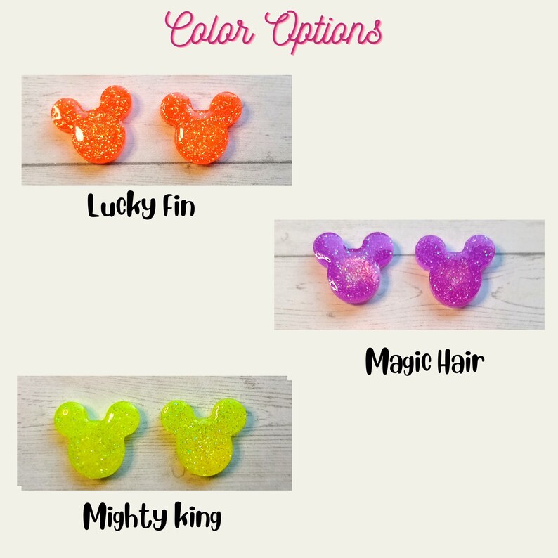 May include: Three sets of glitter mouse ears in different colours. The first set is orange, the second set is purple, and the third set is yellow. The text "Lucky Fin", "Magic Hair", and "Mighty King" are below each set of ears.