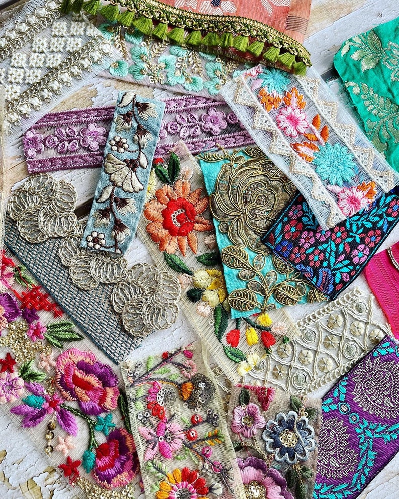 May include: Assortment of colorful embroidered trim with floral and geometric patterns. The trim is made of lace, tulle, and other fabrics. The trim is perfect for adding a touch of elegance to any project.