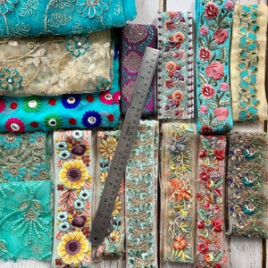 May include: Assortment of colorful embroidered trim with floral and geometric designs. The trim is made of a sheer fabric and is perfect for adding a touch of elegance to any project.