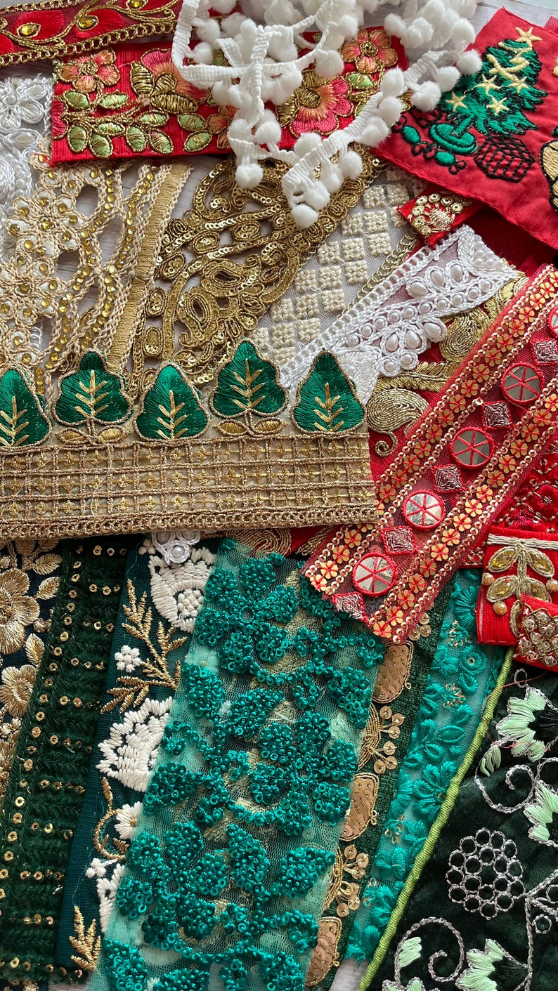 May include: Assortment of green, red, and gold fabric trim with sequins, beads, and embroidery. The trim features various patterns including floral, geometric, and leaf designs.