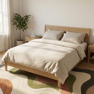 May include: A light wood bed frame with beige bedding and pillows. A colorful, wavy rug in shades of brown, green, and cream sits on the floor. A potted plant and nightstands are on either side of the bed.