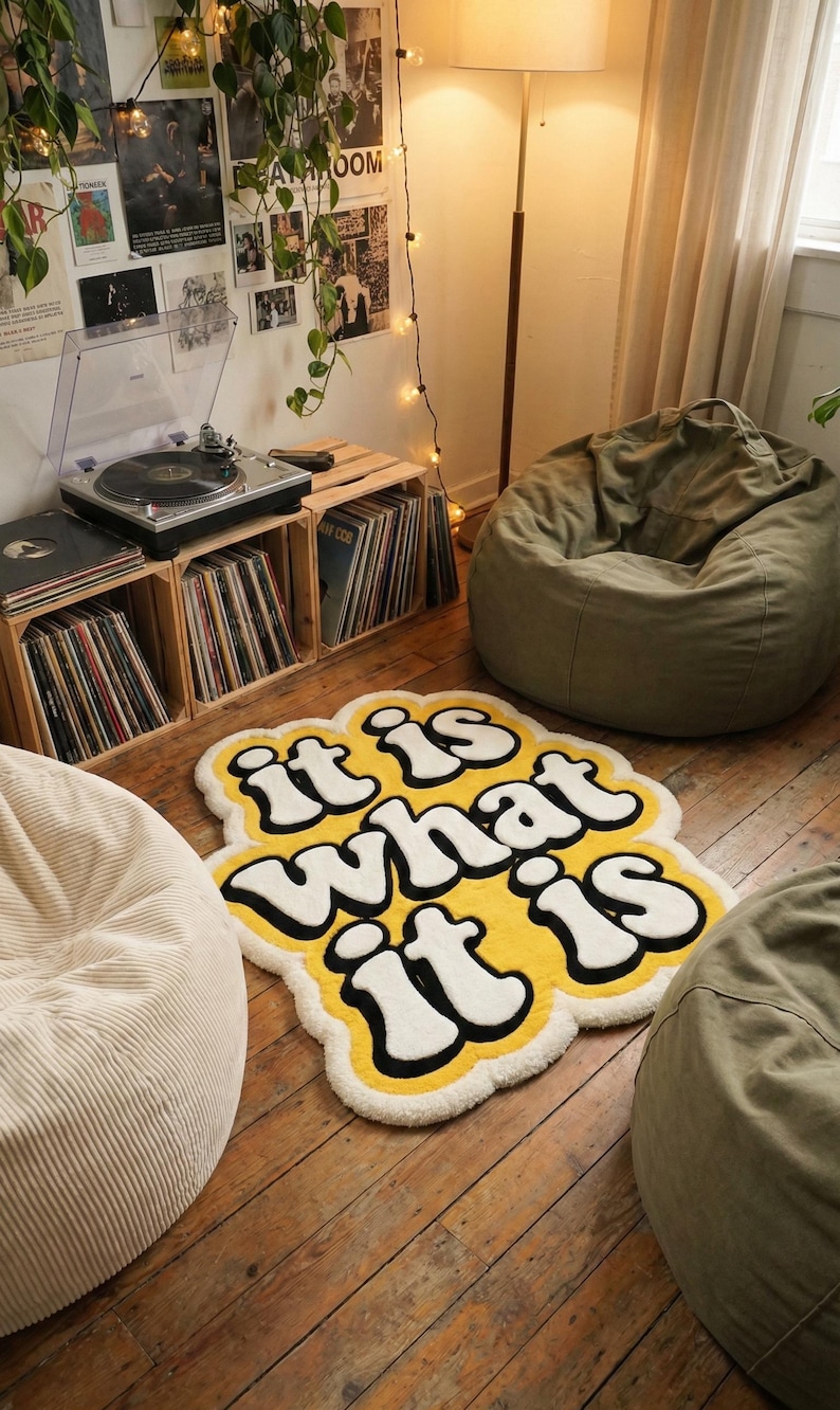 Stylish custom text doormat with “It Is What It Is” in glowing yellow letters on a soft tufted background; rectangular shape fits entryways, living spaces, or bedrooms, combining durability with playful home decor charm.