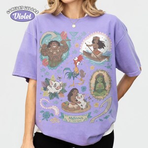 May include: Violet Comfort Colors t-shirt featuring colorful illustrations of characters from the animated film Moana. The design includes images of Maui, Moana, Pua, Hei Hei, and other elements from the movie. The text "MOANA & FRIENDS" is also visible.