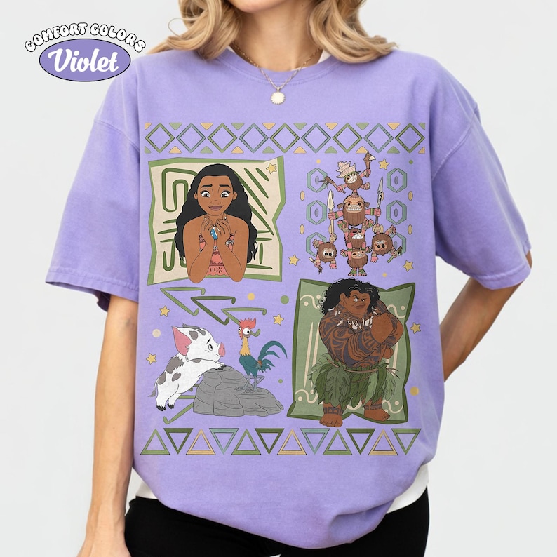 May include: A light purple short-sleeve t-shirt featuring a graphic print of characters from the movie Moana, including Moana, Maui, Pua, Heihei, and Kakamora. The design includes geometric patterns, stars, and the text Comfort Colors Violet.