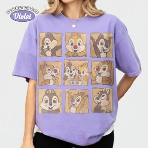 May include: A lilac Comfort Colors t-shirt with a grid of nine squares, each displaying a different image of Chip and Dale. The tee has short sleeves and a relaxed fit, with the words "Comfort Colors" and "Violet" in a circular design.