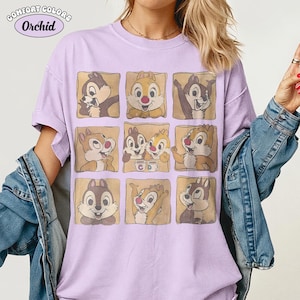 May include: A lilac Comfort Colors t-shirt with a grid of nine cartoon chipmunk images. The shirt has the text "Comfort Colors" and "Orchid" in a circular design at the top left.