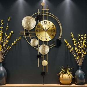 May include: A gold-coloured wall clock with a circular face and Roman numerals. The clock has a decorative frame with geometric shapes and a pendulum. The clock is surrounded by decorative vases with yellow flowers.