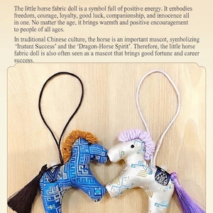 May include: Two small fabric horse dolls with hanging strings. One is blue with a brown mane and black tassel, the other is white with a purple mane and tassel. The text above reads "Symbolism of the Little Horse".