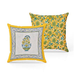 May include: Two square decorative pillows. One pillow features a yellow border with a white center, showcasing a floral design in yellow, blue, and green. The other pillow has a yellow background with a green and blue floral pattern.