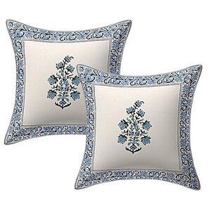 May include: Two square throw pillows with a cream background and a floral design. The pillows have a blue floral border and a central floral motif in blue and green. The design is symmetrical and detailed.
